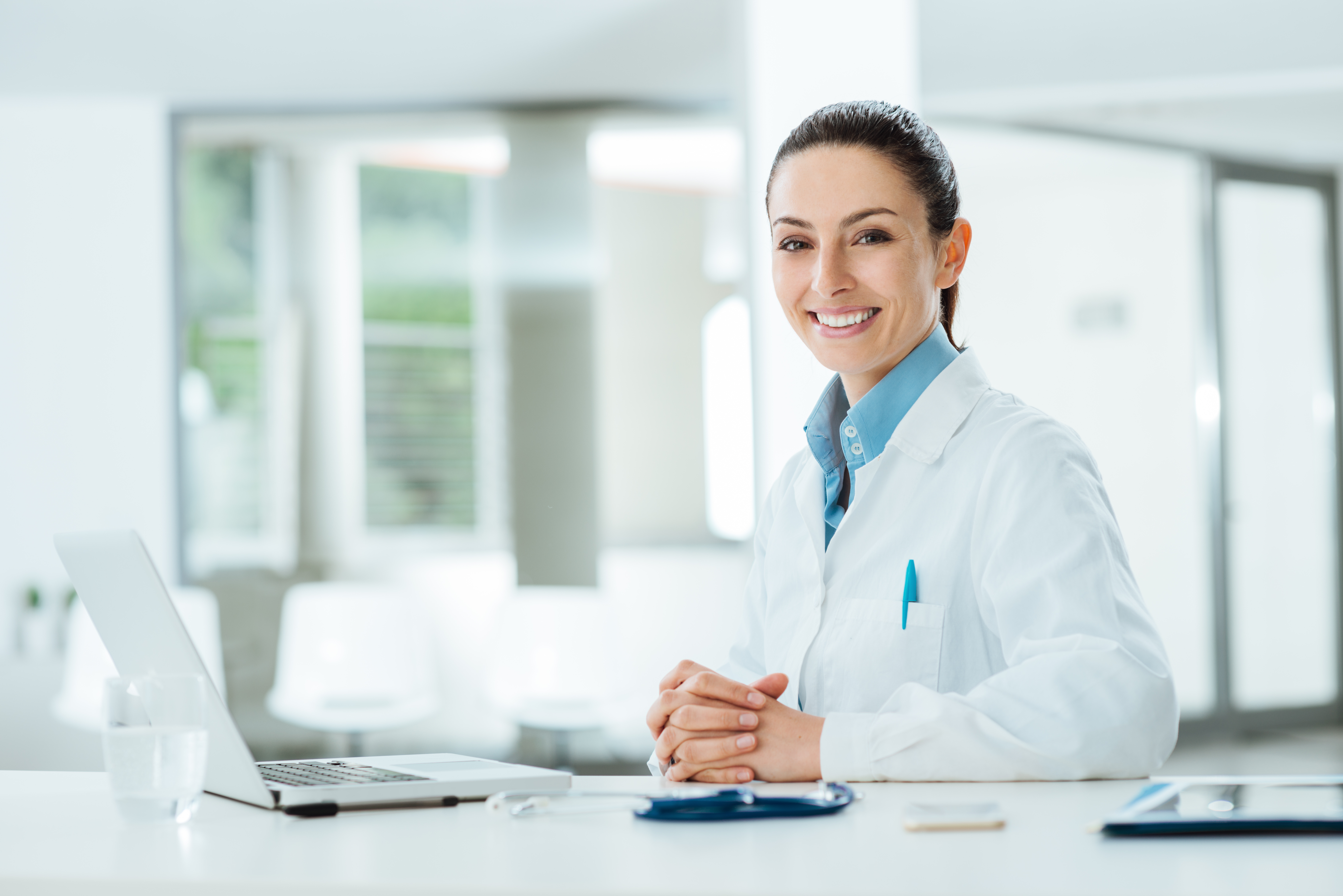 Smiling female doctor with laptop